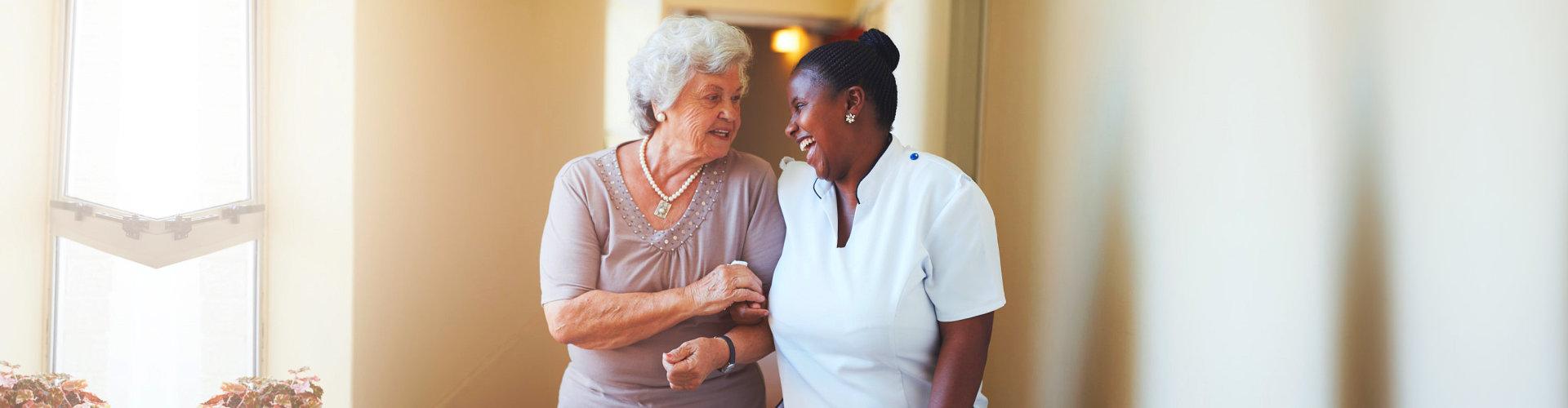 female aide and elderly woman talking