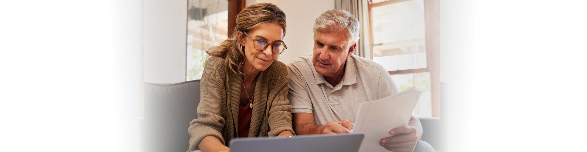 elderly couple looking at the laptop